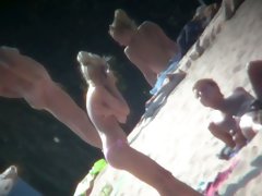 Beach voyeur vid features a hot blonde topless girl.