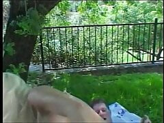 Busty blonde has threesome in the park