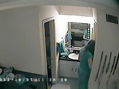 Woman takes off pajama in bedroom