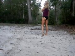 frisky blonde striptease outside in nature gets topless with nice ass