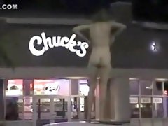 Skinny exhibitionist undresses in a fast food parking lot