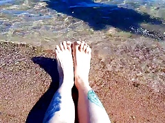Dominatrix Nika enjoys the salty sea on her feet.